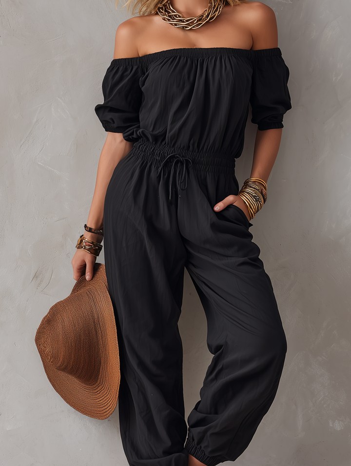 Maj – Avslappnad jumpsuit med off-shoulder-ringning